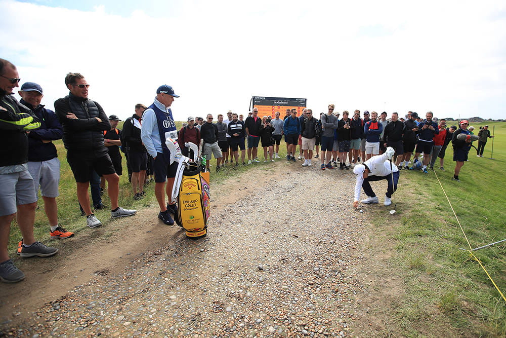 Emiliano Grillo removing stones around his ball